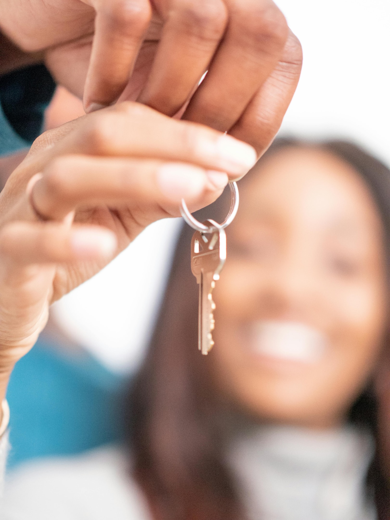 Real estate investor team holds keys to newly purchased property in Austin, Texas.