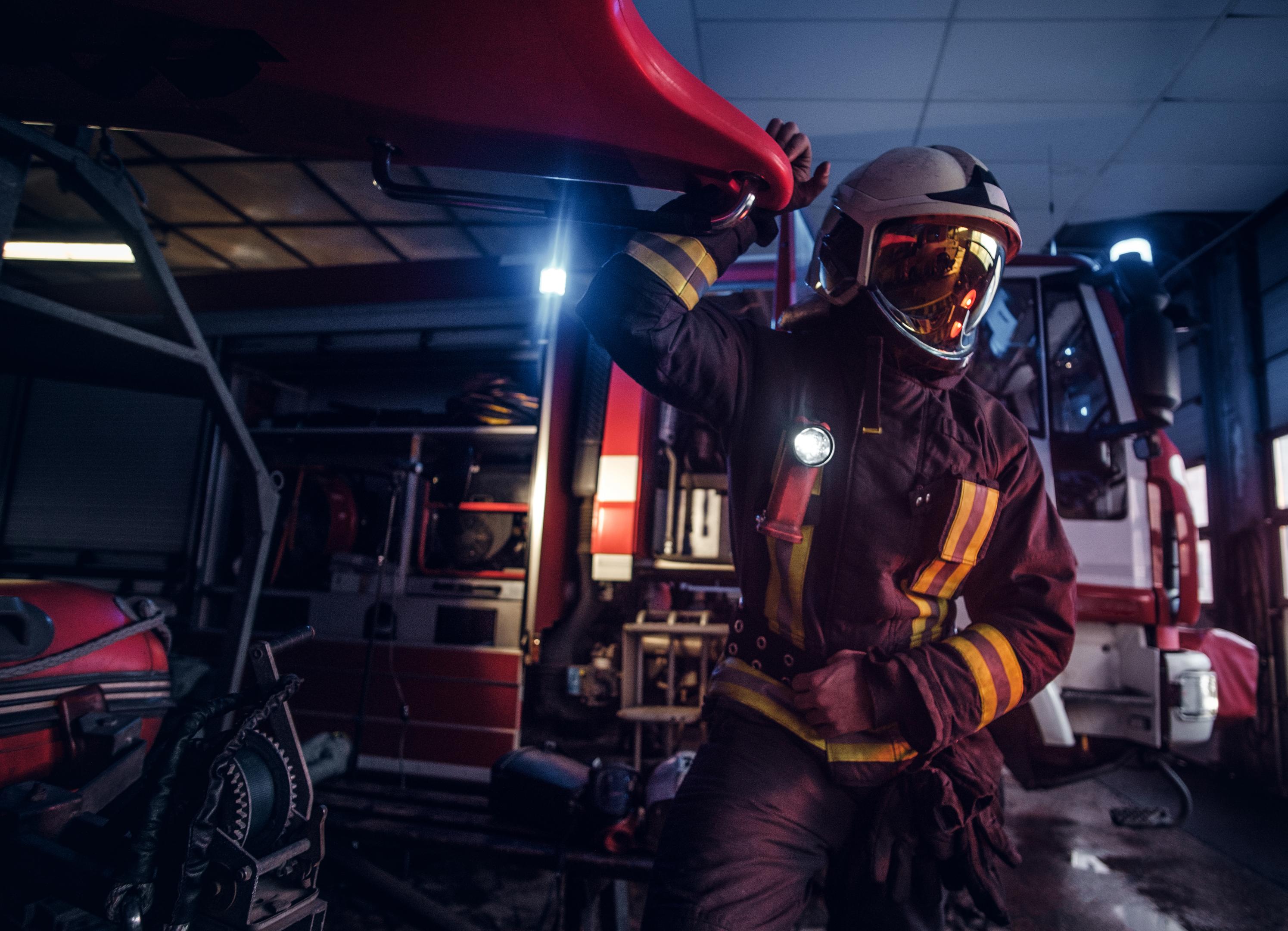 Firefighter standing next to a fire engine