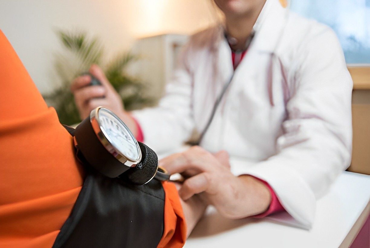A photo of a doctor using a blood pressure to his client