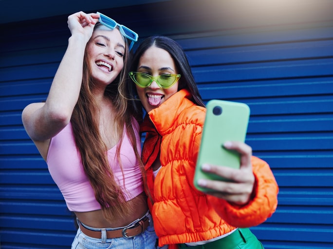 Two young women snapping a selfie. 