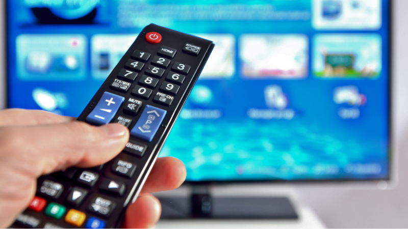 A man is pressing the remote control.