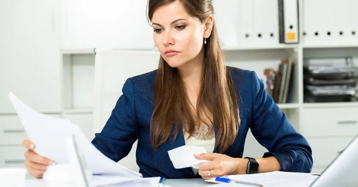 Woman reviewing an LT11 notice with tax documents at her home office.