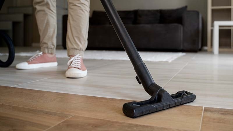 A person vacuuming their floor