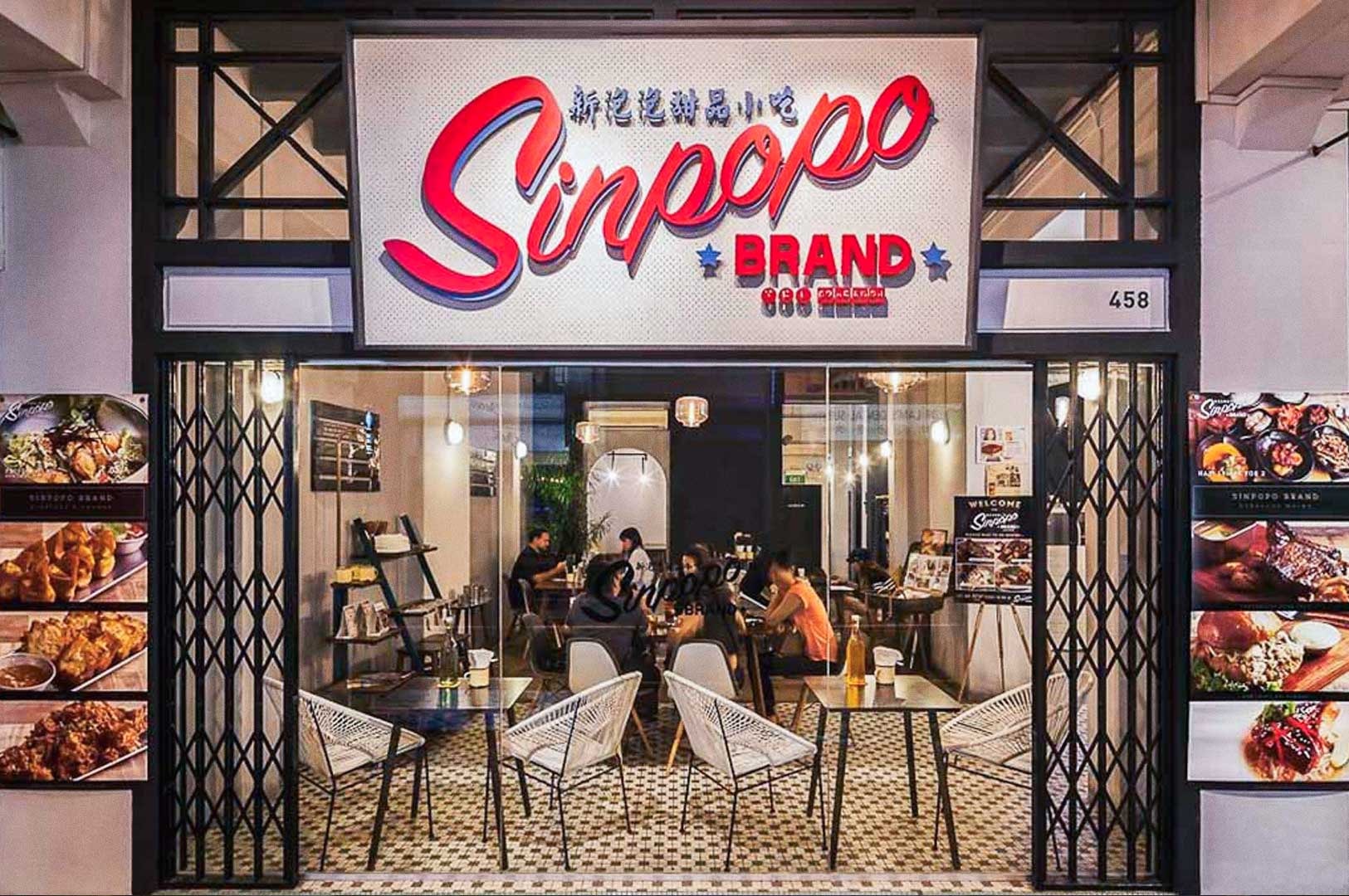 Sinpopo Brand café entrance with retro‑style décor and diners inside.