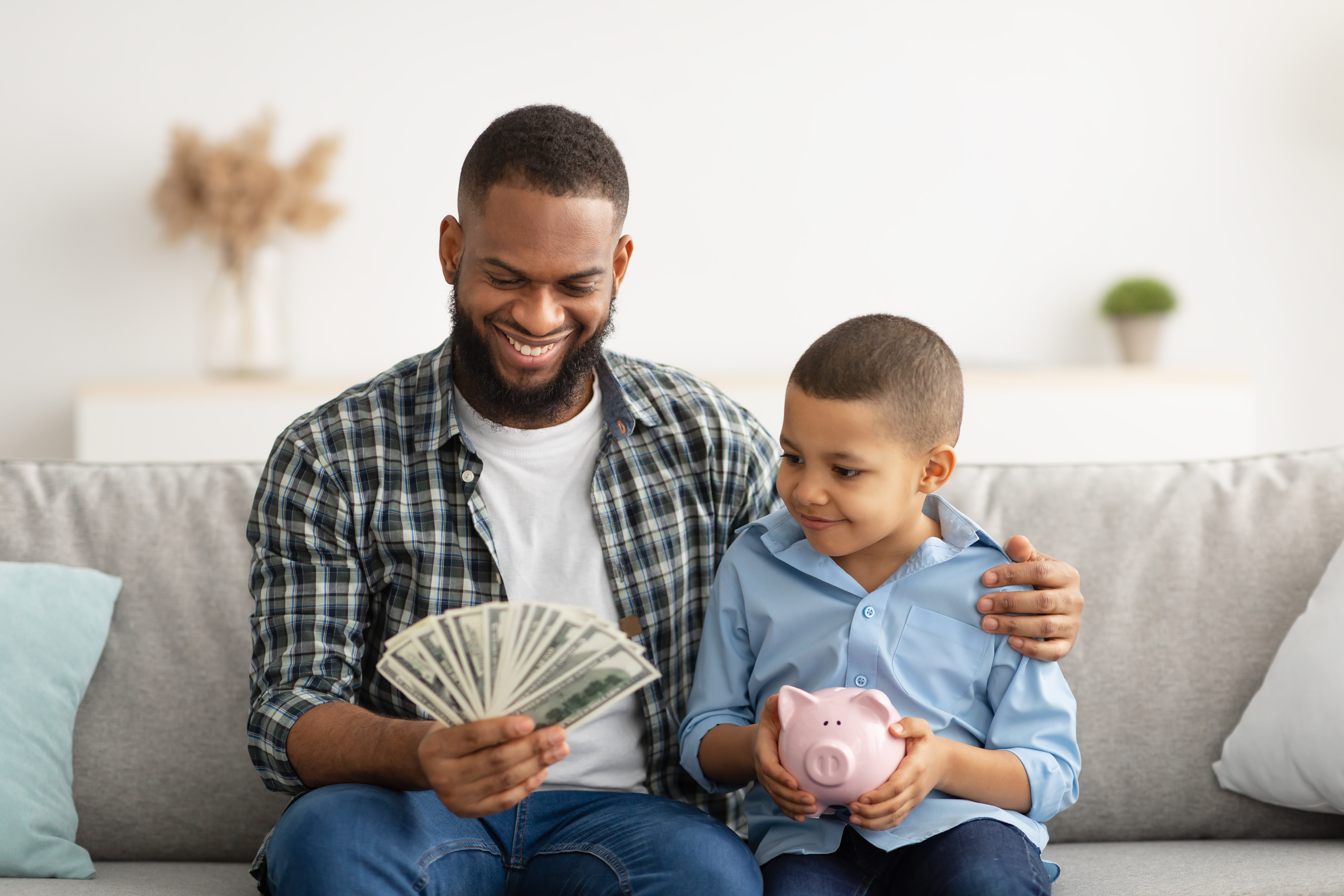 "Empowering the next generation: A father teaches his son about the financial stability and opportunities that come with trust fund benefits."