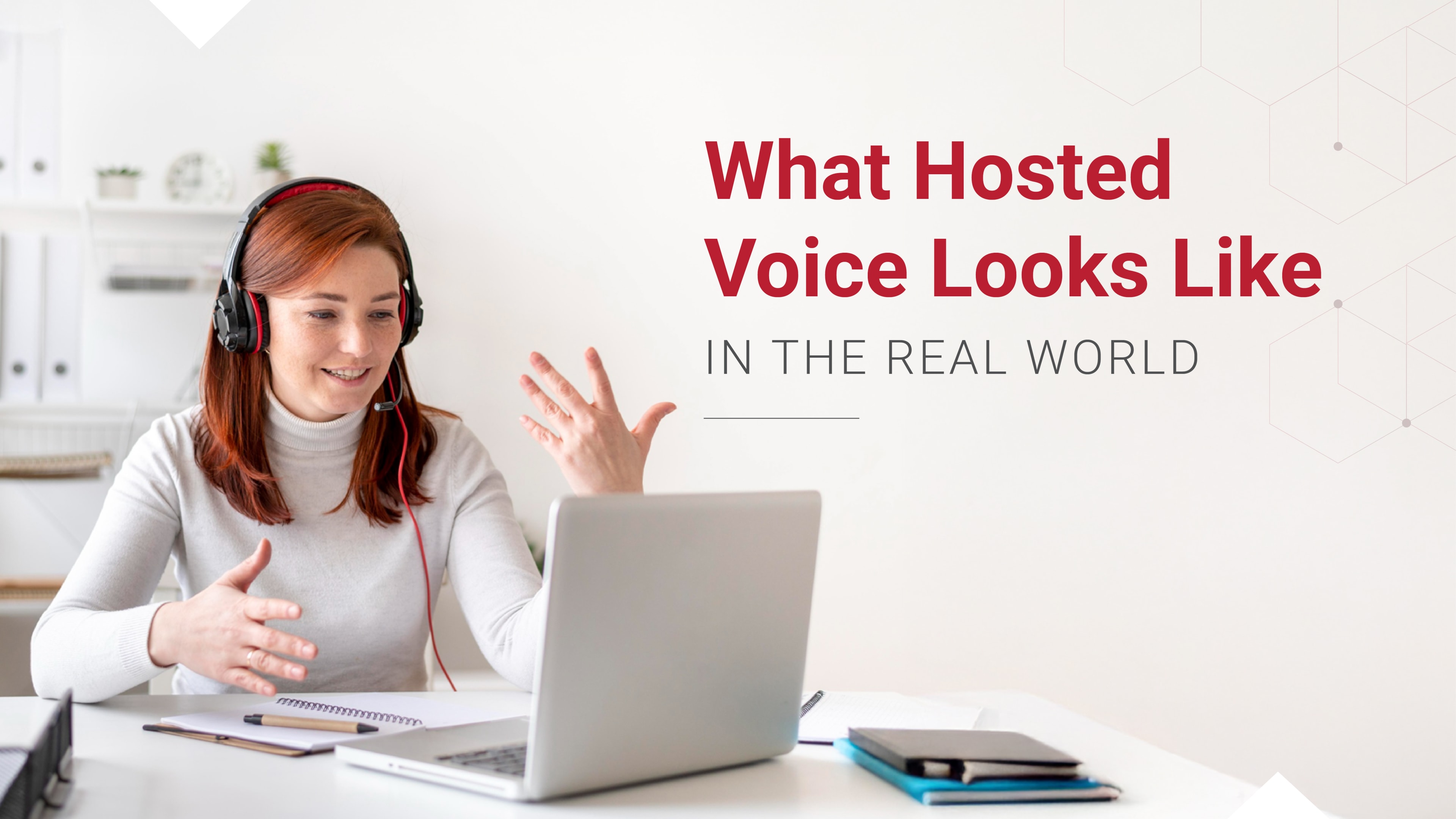 Smiling woman wearing a headset gestures while speaking on a video call.