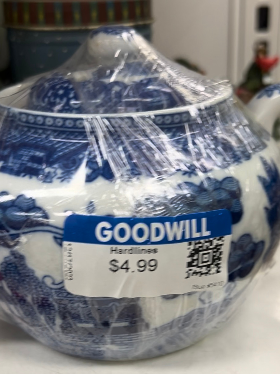 An inexpensive blue and white teapot for sale at a local Goodwill store.