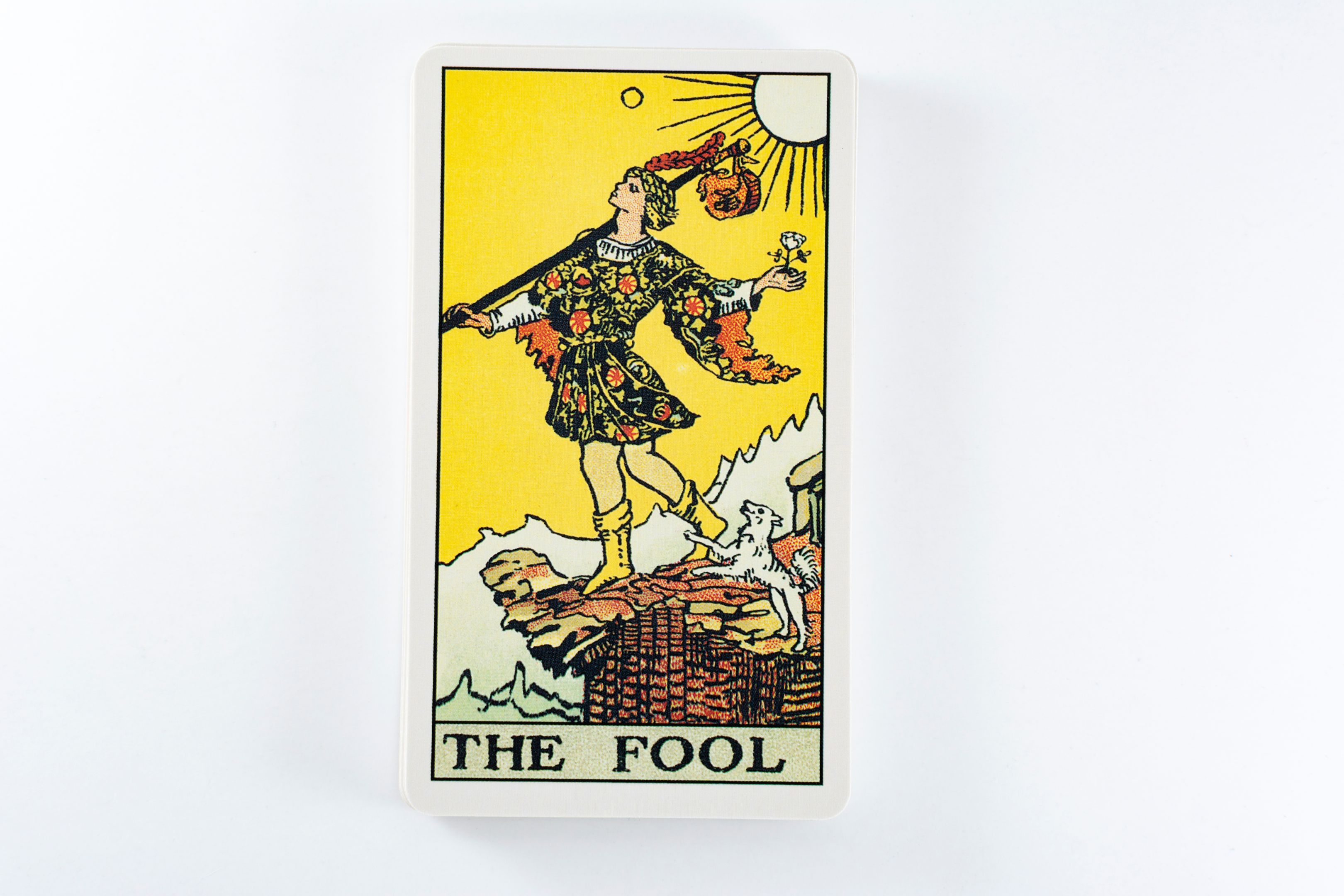the fool tarot card, a young man stepping off a cliff's ledge