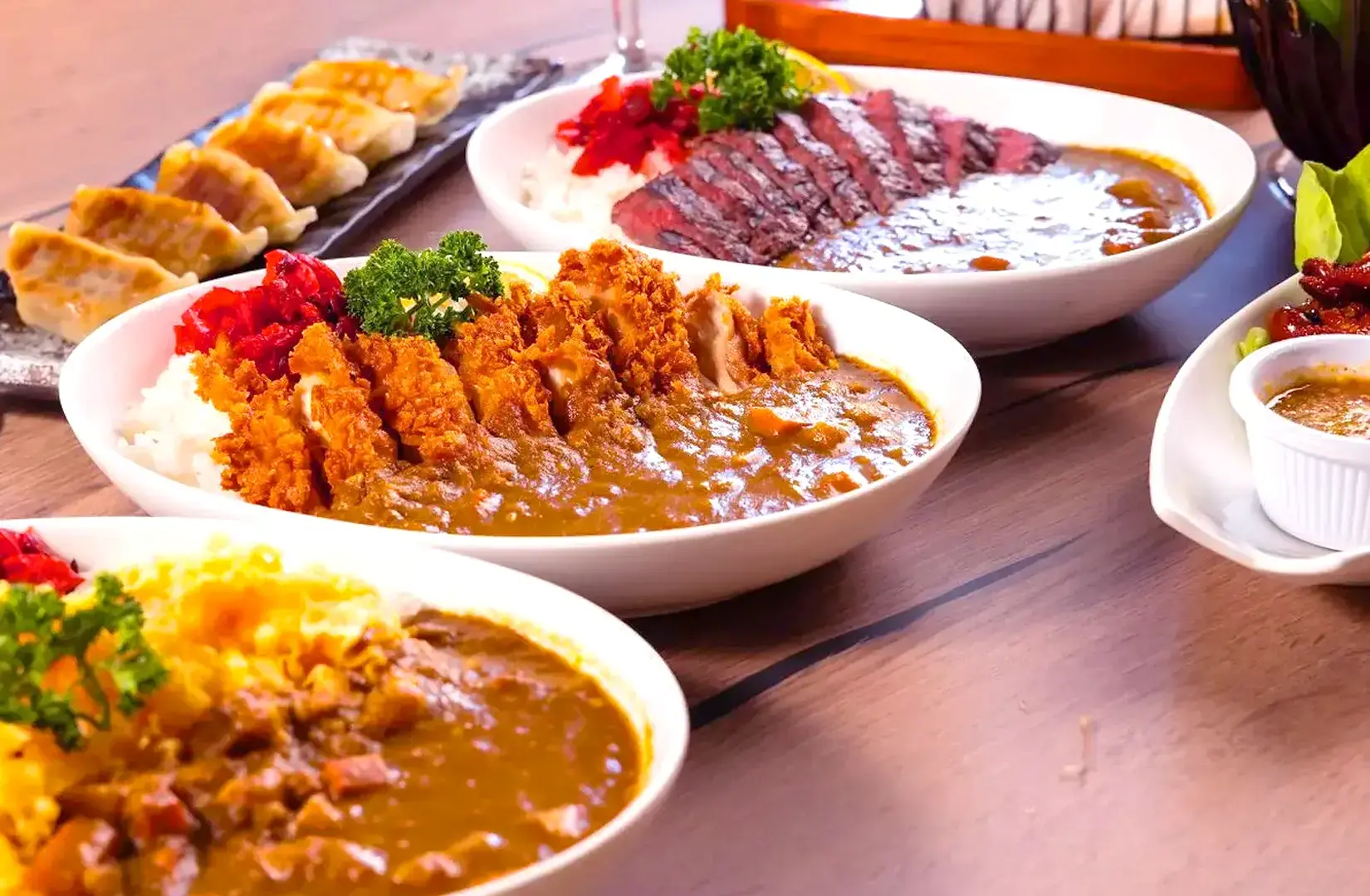 Monster Curry Singapore Japanese curry spread featuring chicken katsu curry, beef curry and gyoza