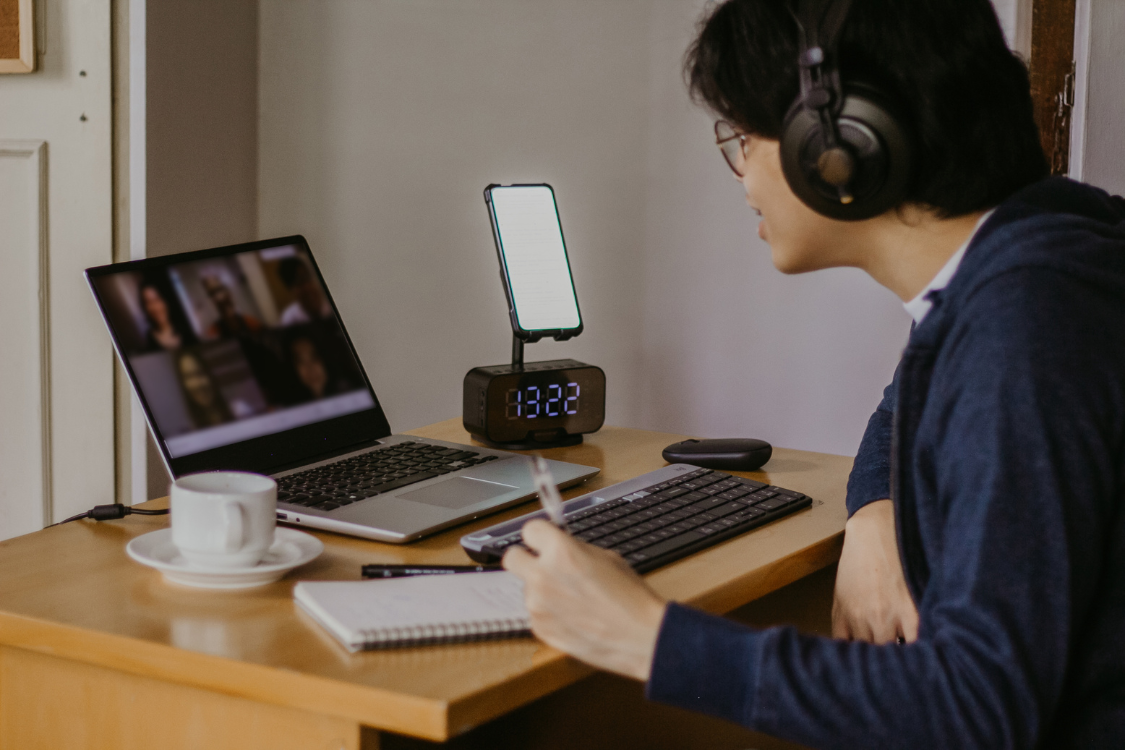 A Filipino professional sitting at a desk during a virtual interview session.