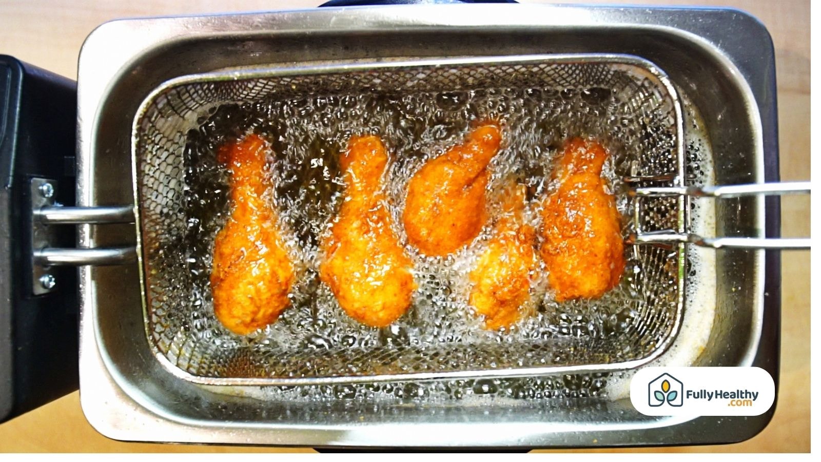 Fried chicken drumsticks in deep fryer using avocado oil