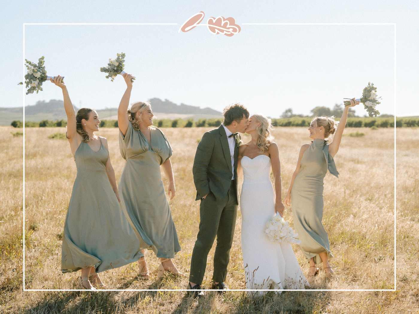 Tess and Greg kissing in a Cape Winelands field as her bridesmaids raise their white and green bouquets in celebration