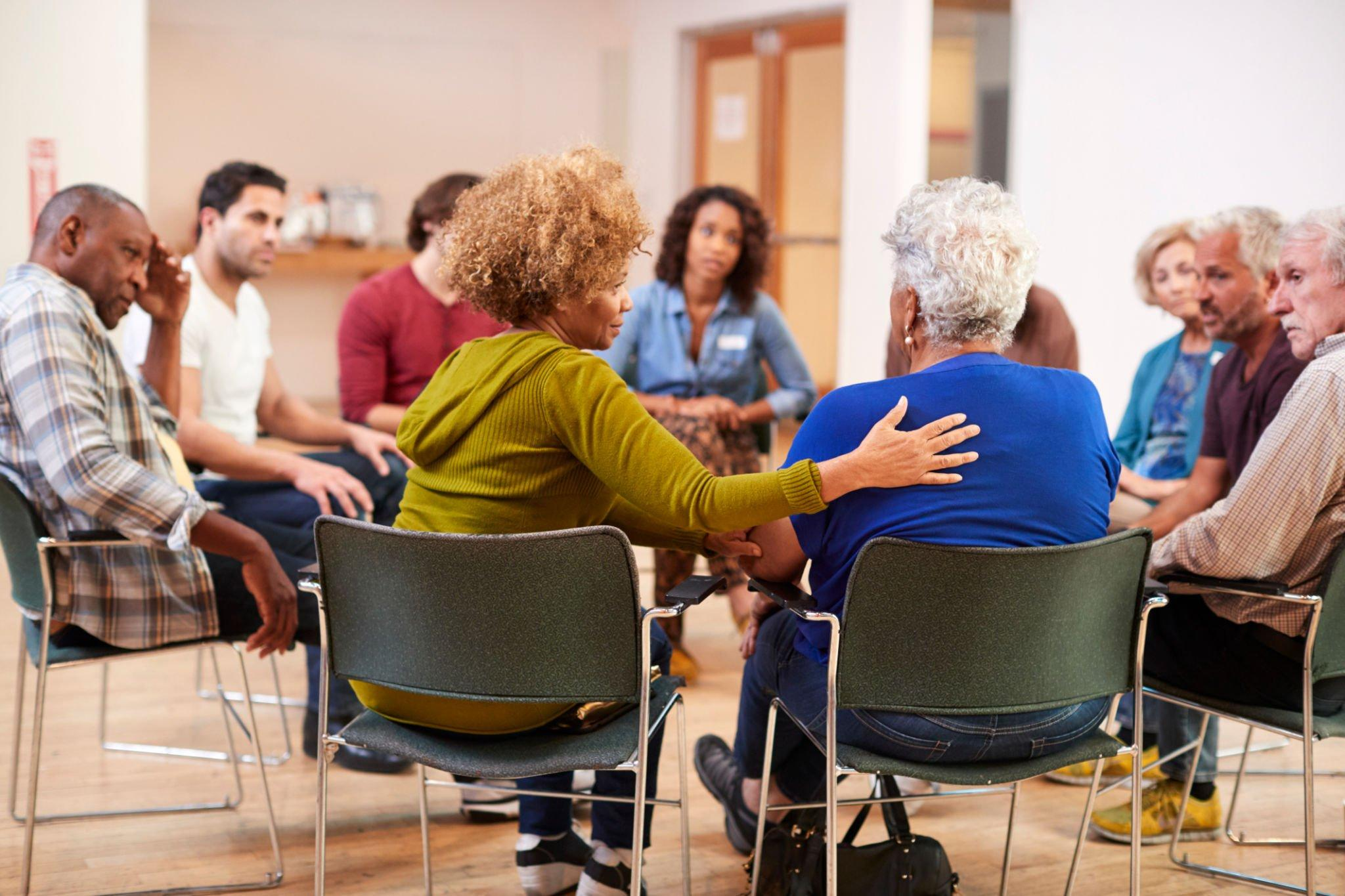 A supportive gathering of individuals in a support group, discussing the intersection of stress and diabetes, sharing methods to completely eliminate stress, and exploring various stress management therapies.