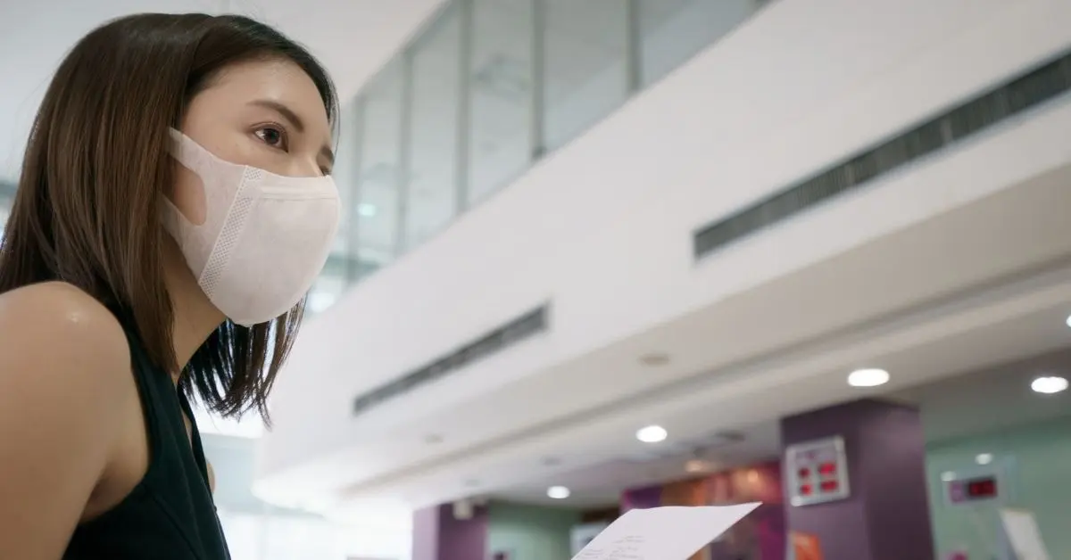 A woman checking documents, potentially reviewing excess Social Security tax withheld at an office.