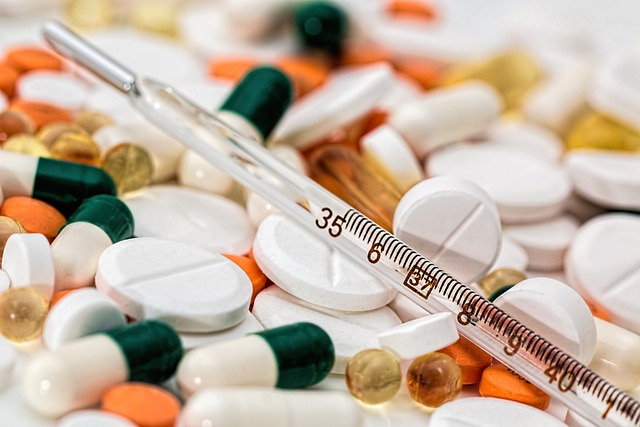 A thermometer, and a number of medications and tablets.