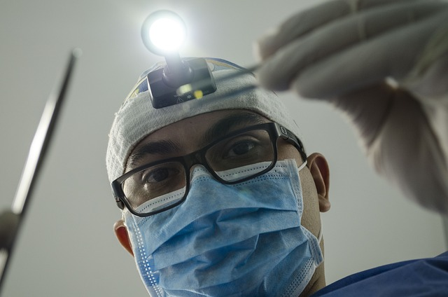 An image of a dentist shining a light into a patient's mouth.