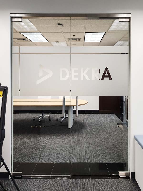 Part of a series of interior signs for Dekra in Oxnard, this custom privacy film adds both function and style to the conference room while maintaining a clean, professional look.