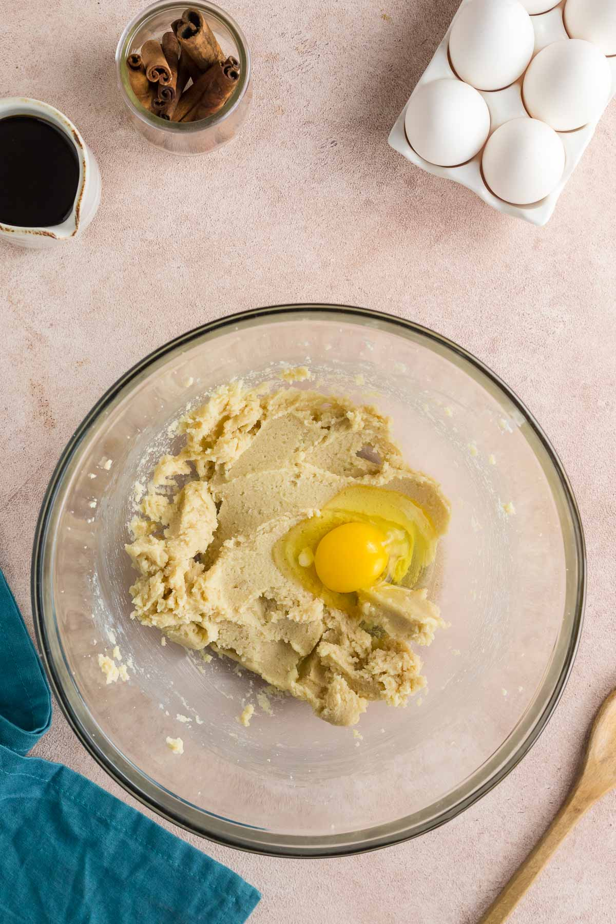 egg added to molasses cookie dough in bowl