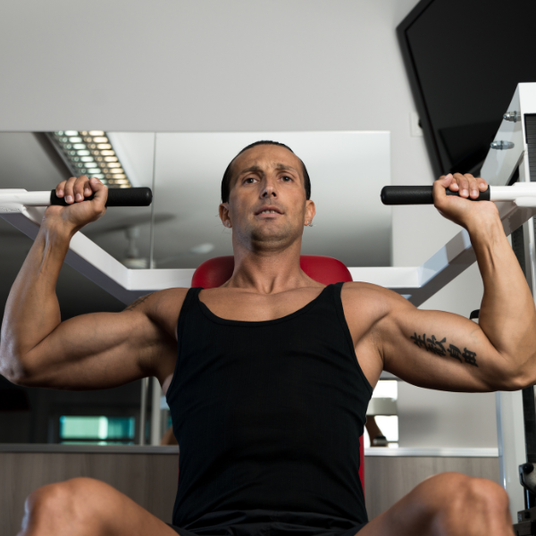 An image of a person performing a shoulder press with proper form.