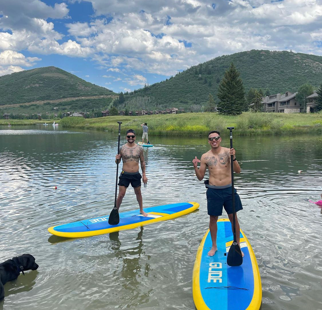 2 men on solid paddle boards