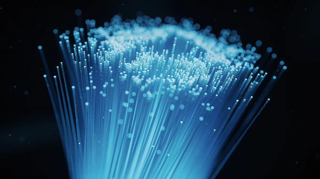 La imagen muestra cables de fibra óptica azules brillantes agrupados, transmitiendo luz para facilitar una transmisión de datos más rápida para conexiones a internet fiables. Estos cables son esenciales para los servicios de banda ancha de alta velocidad, incluidas las conexiones de línea de abonado digital asimétrica (ADSL), que mejoran las velocidades de carga y descarga para los usuarios.