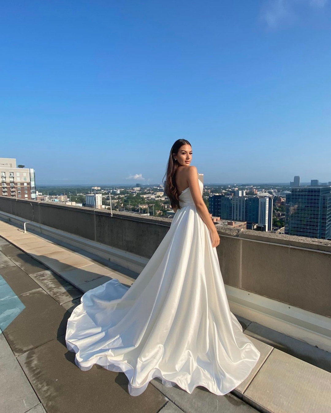 A bride wearing a classic A-line wedding gown with a sweetheart neckline and simple bodice