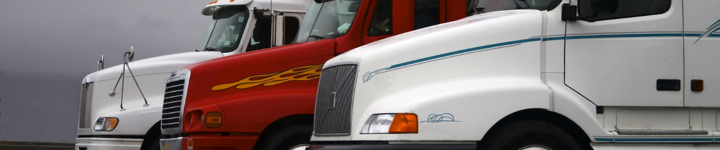 An image of semi trucks in a row representing how truck accident lawyers defend Fort Lauderdale truck accident victims against large trucking companies