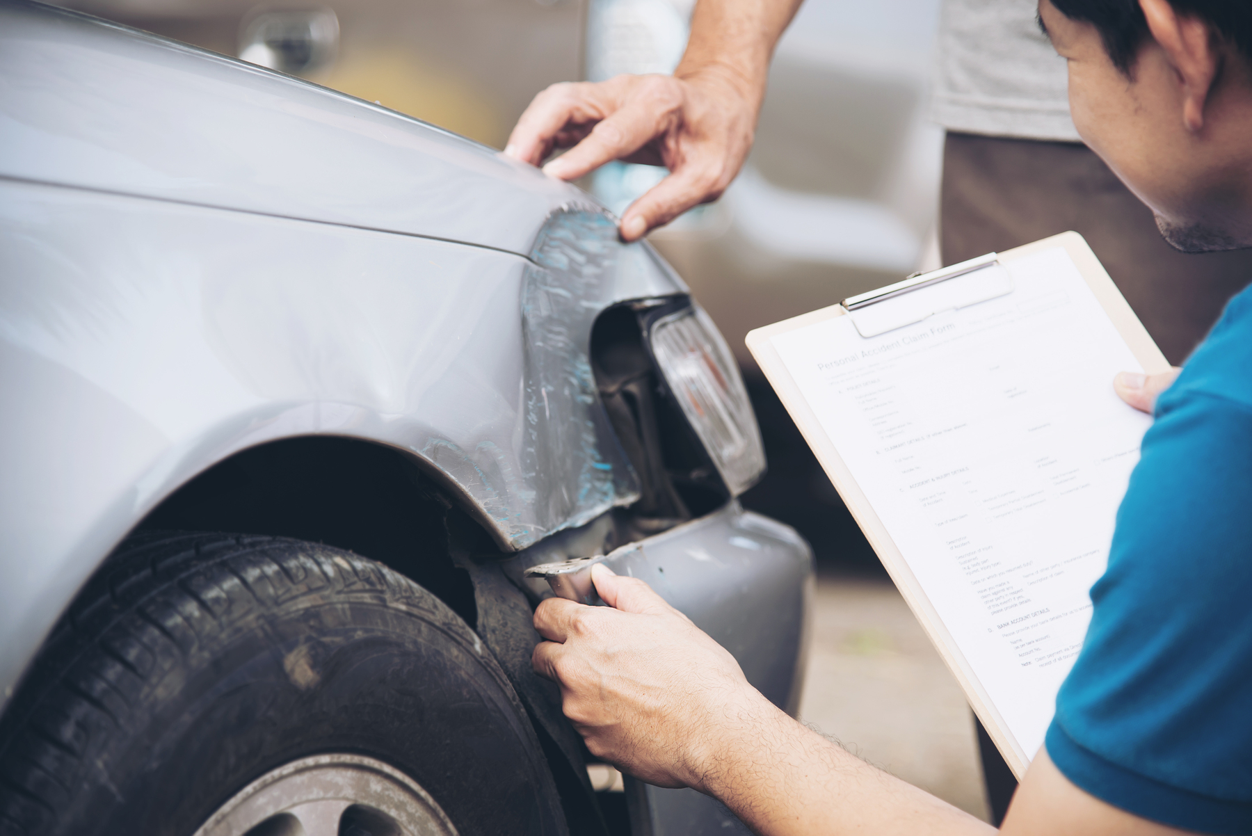 Professional inspecting and evaluating a car scratch for precise automotive repair