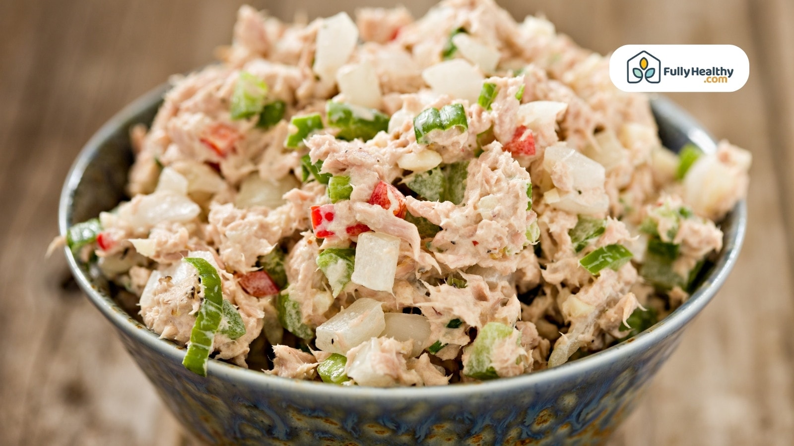 Tuna salad with chopped vegetables in a blue bowl