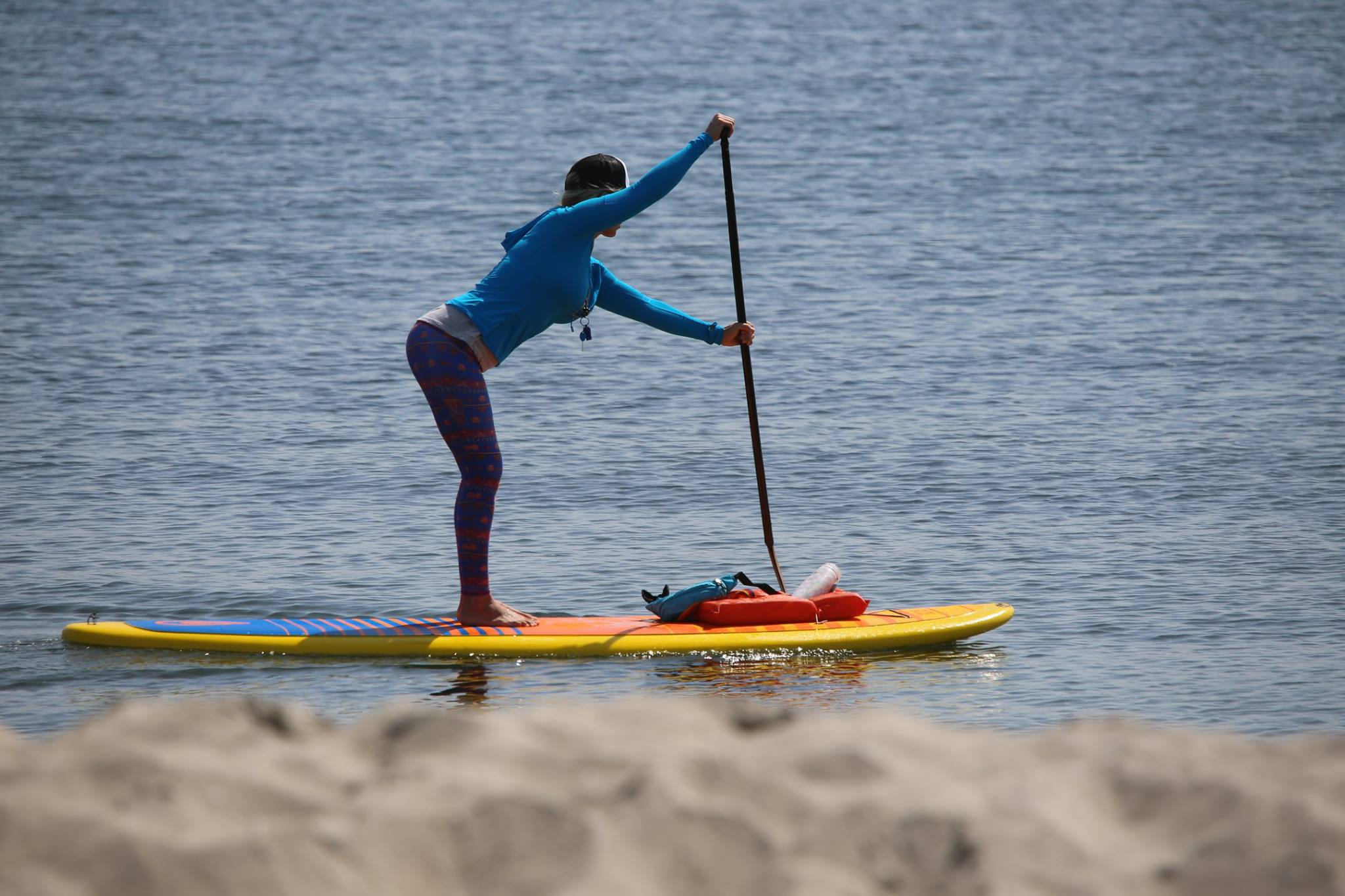 solid paddle boards and an inflatable board with paddle holder