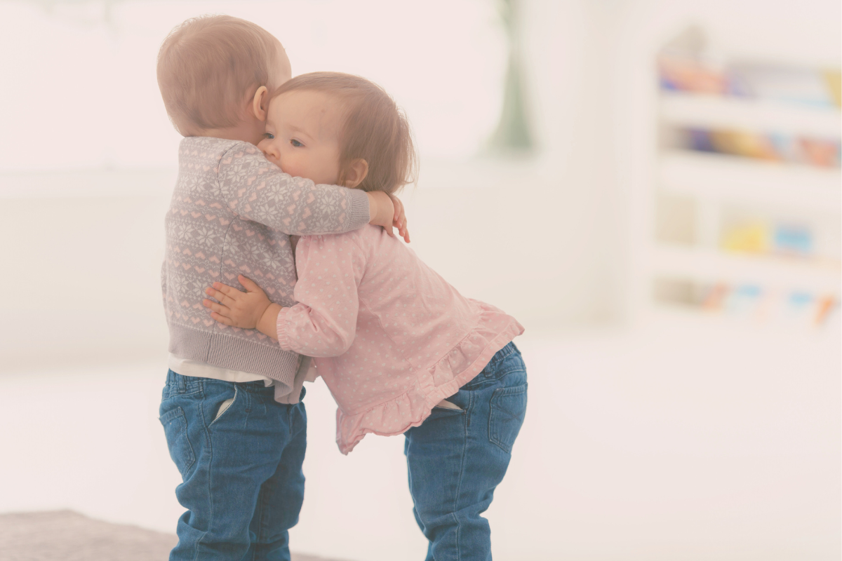 Two small children hugging