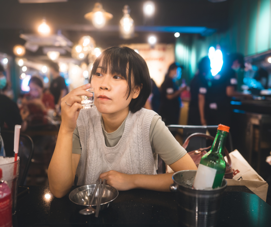 A person drinking alcohol in a bar