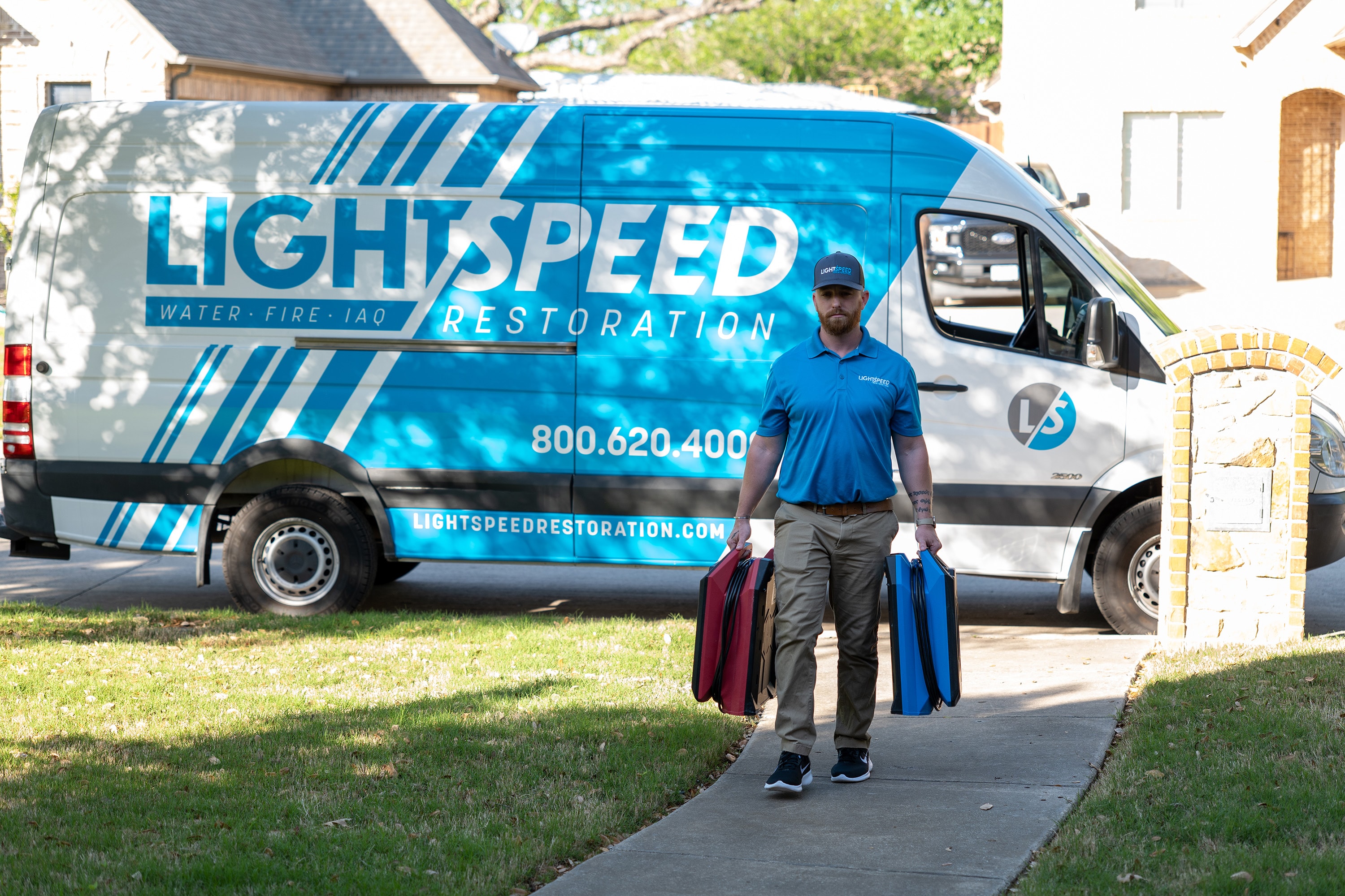 A professional restoration crew is arriving at a residential property in Austin, equipped with tools for water damage restoration and mold remediation. Their presence indicates a response to potential water intrusion or mold growth, aimed at minimizing further damage and ensuring the safety of the home.