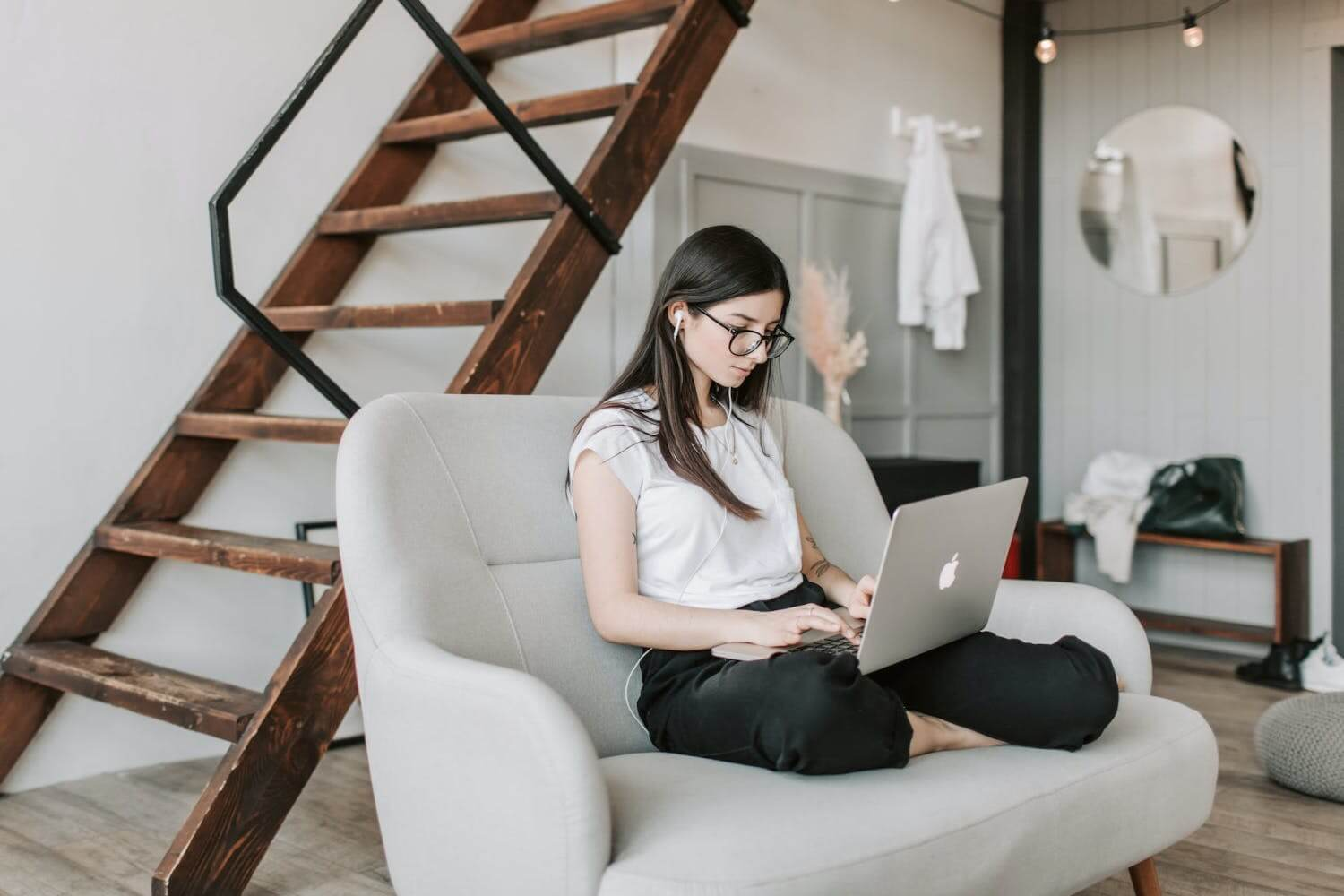 a middle manager sitting on a sofa with their laptop creating an effective communication strategy