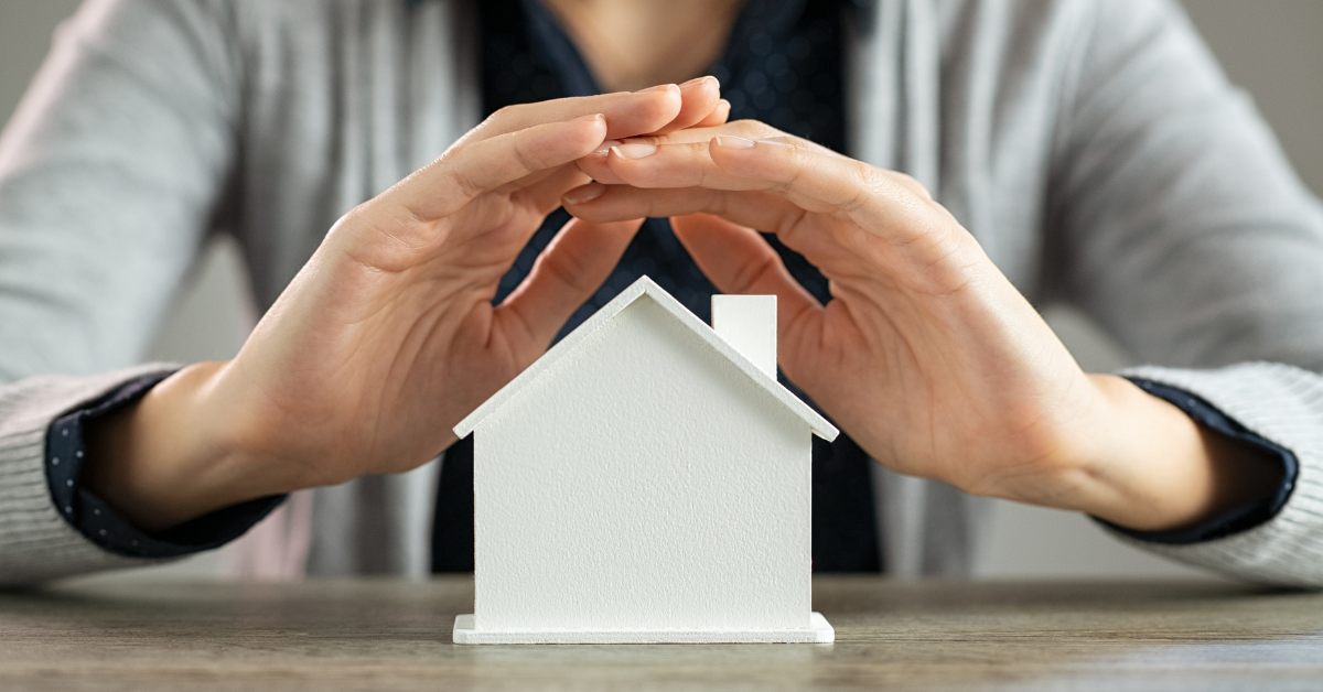 Image of a person protecting a home to symbolize the homestead exemption