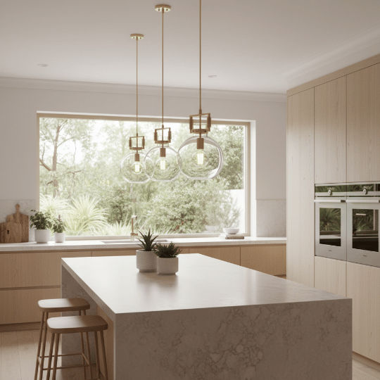 Modern glass globe pendant lights above a kitchen island, highlighting contemporary lighting ideas with warm brass accents