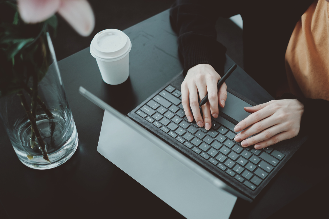 Hands of a Filipino remote worker typing on a keyboard during a virtual assistant assessment