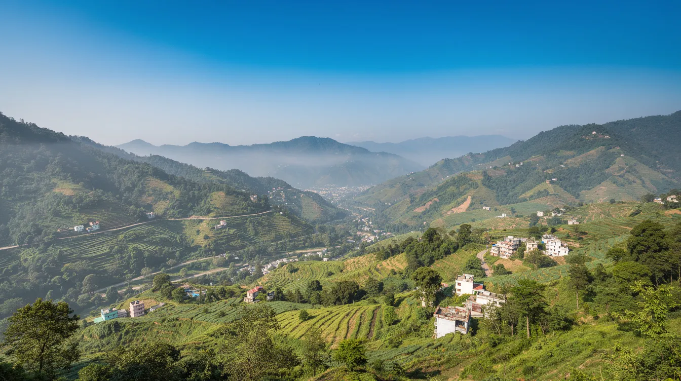 The image showcases a breathtaking panoramic view of Dehradun valley, featuring lush green hills beneath a clear blue sky, highlighting the area's picturesque landscapes and potential as a business hub. This serene setting is ideal for aspiring entrepreneurs looking to explore profitable business ideas in the tourism sector and beyond.