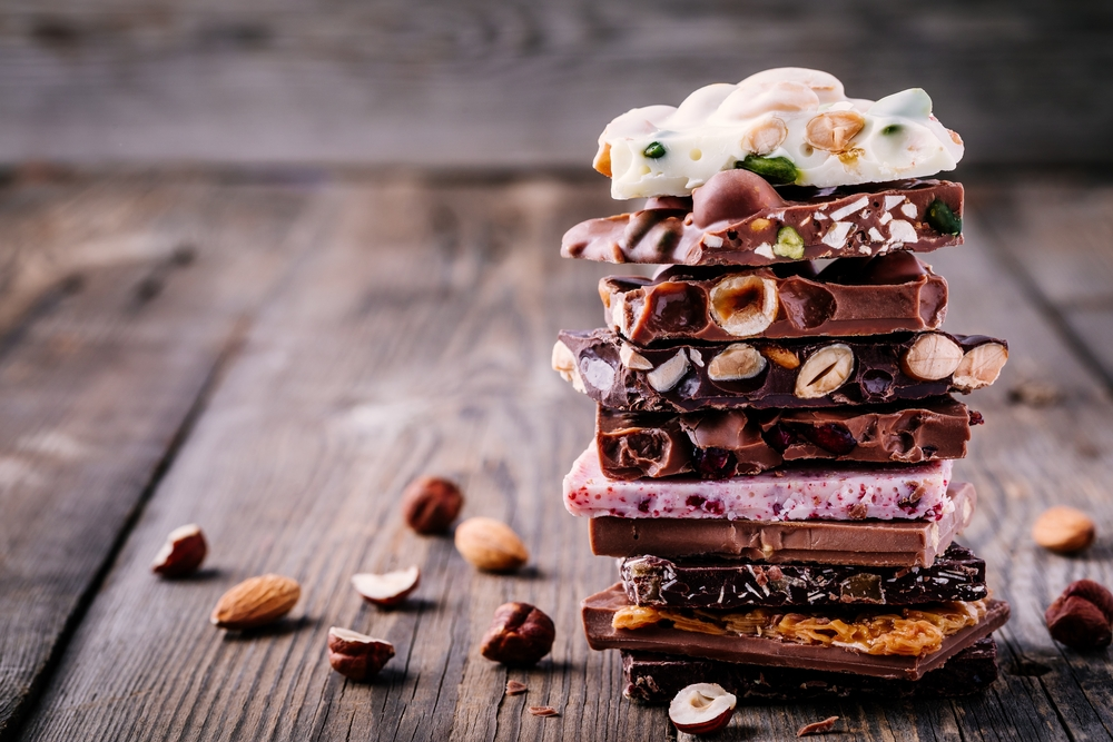 Stack of White, Milk and Dark Chocolate with Nuts, Caramel