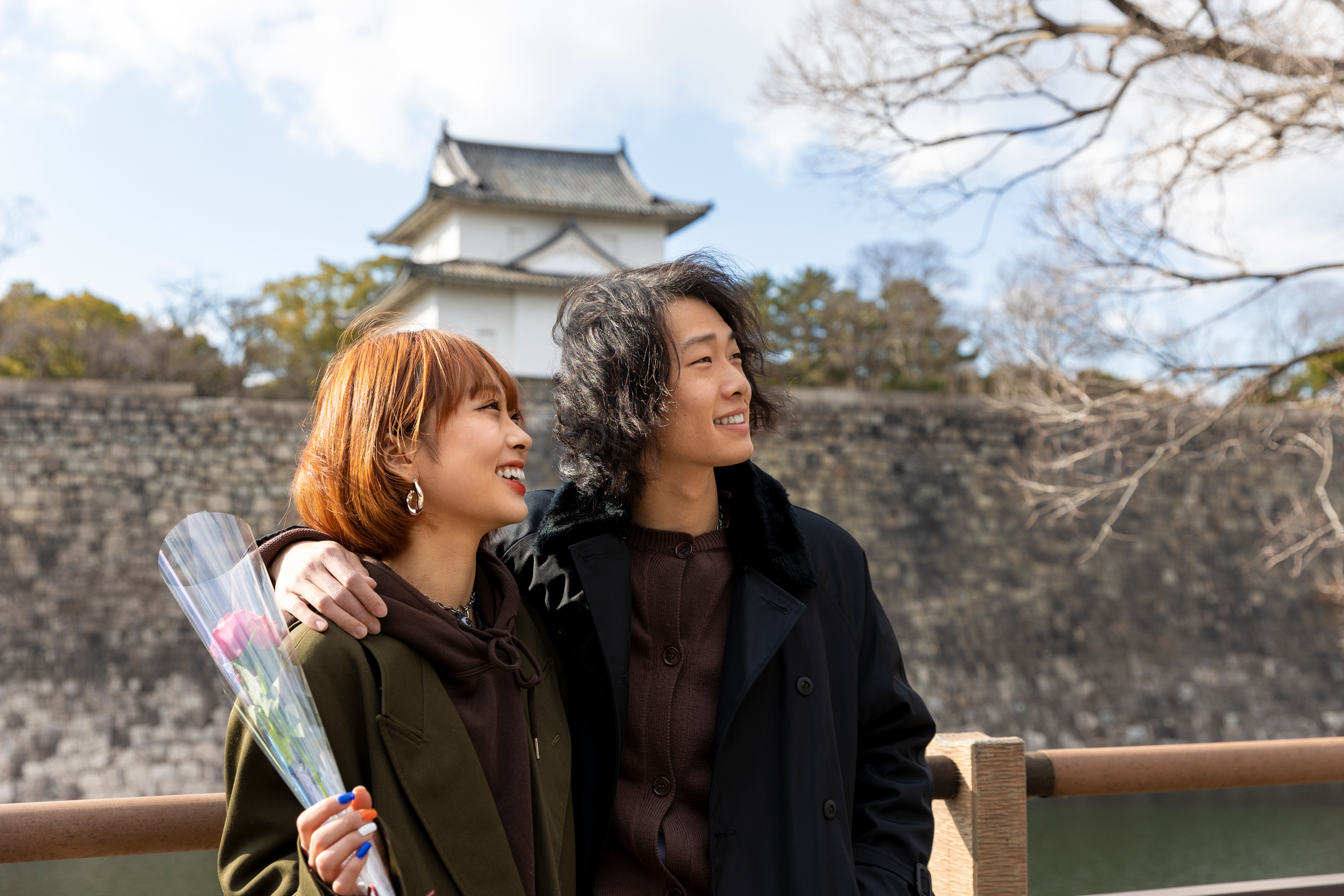 Cute japanese couple out on a date with rose flower, via Freepik