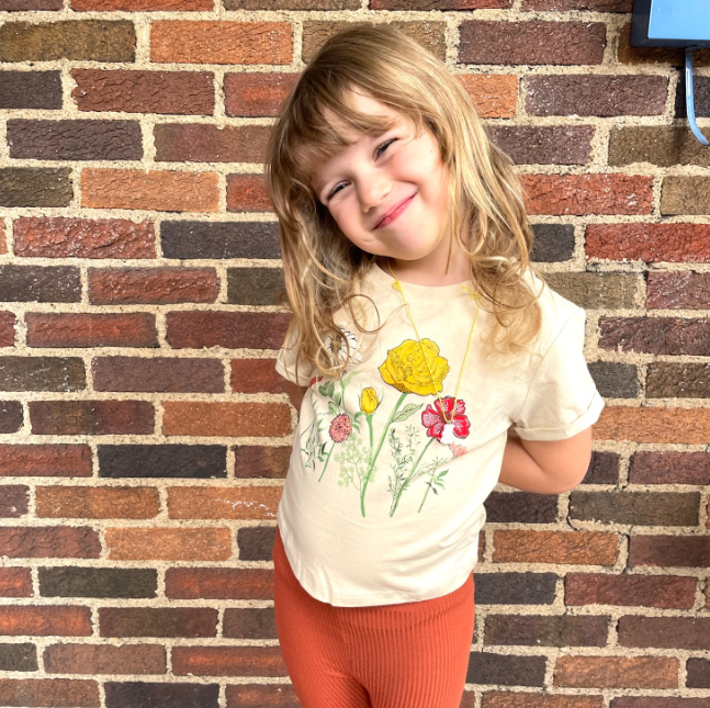 Christen's daughter modeling her new Floral Cuffed Tee from Kidpik's kids' clothing membership.