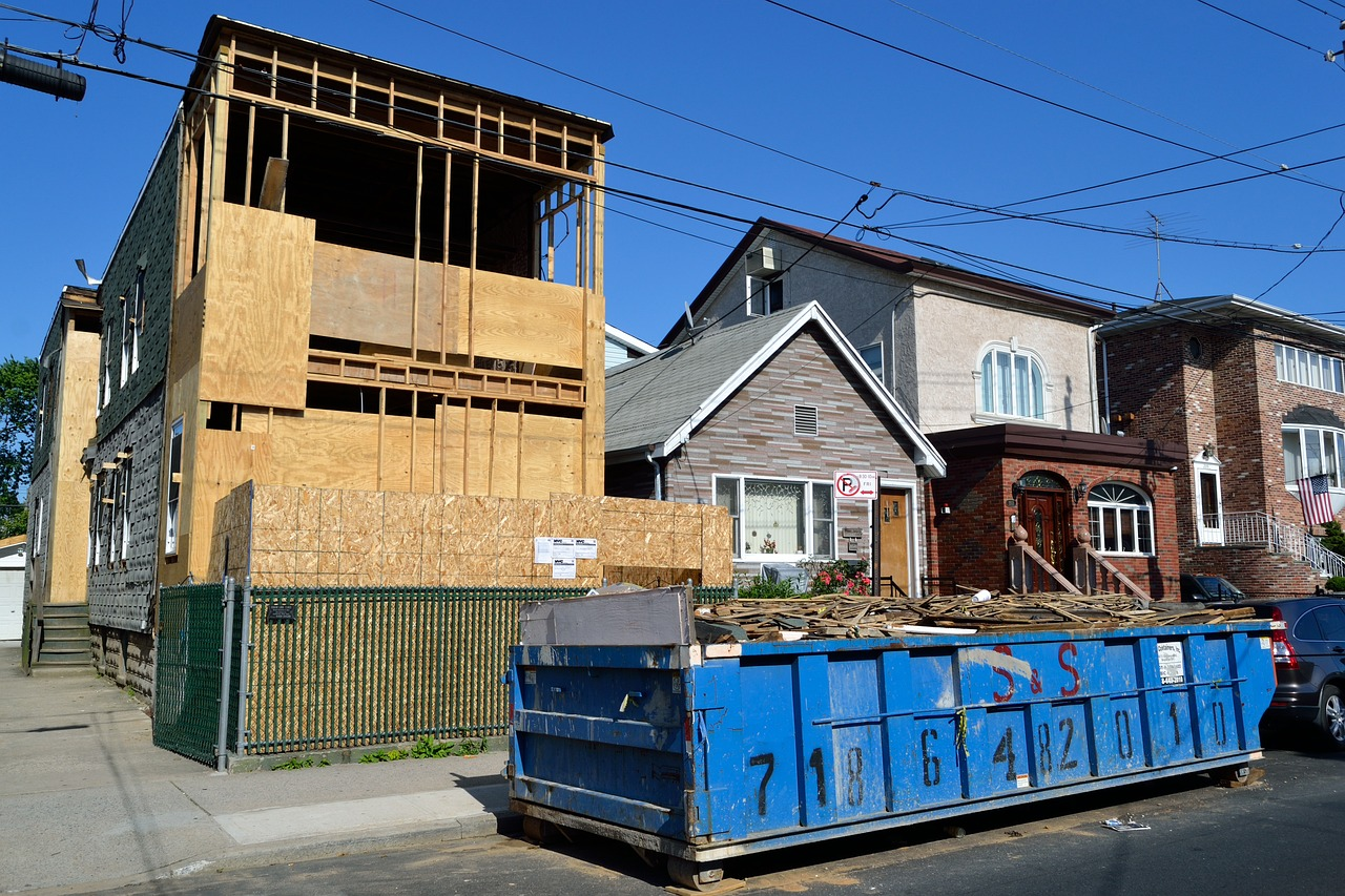 House Under Construction With Blue Dumpster