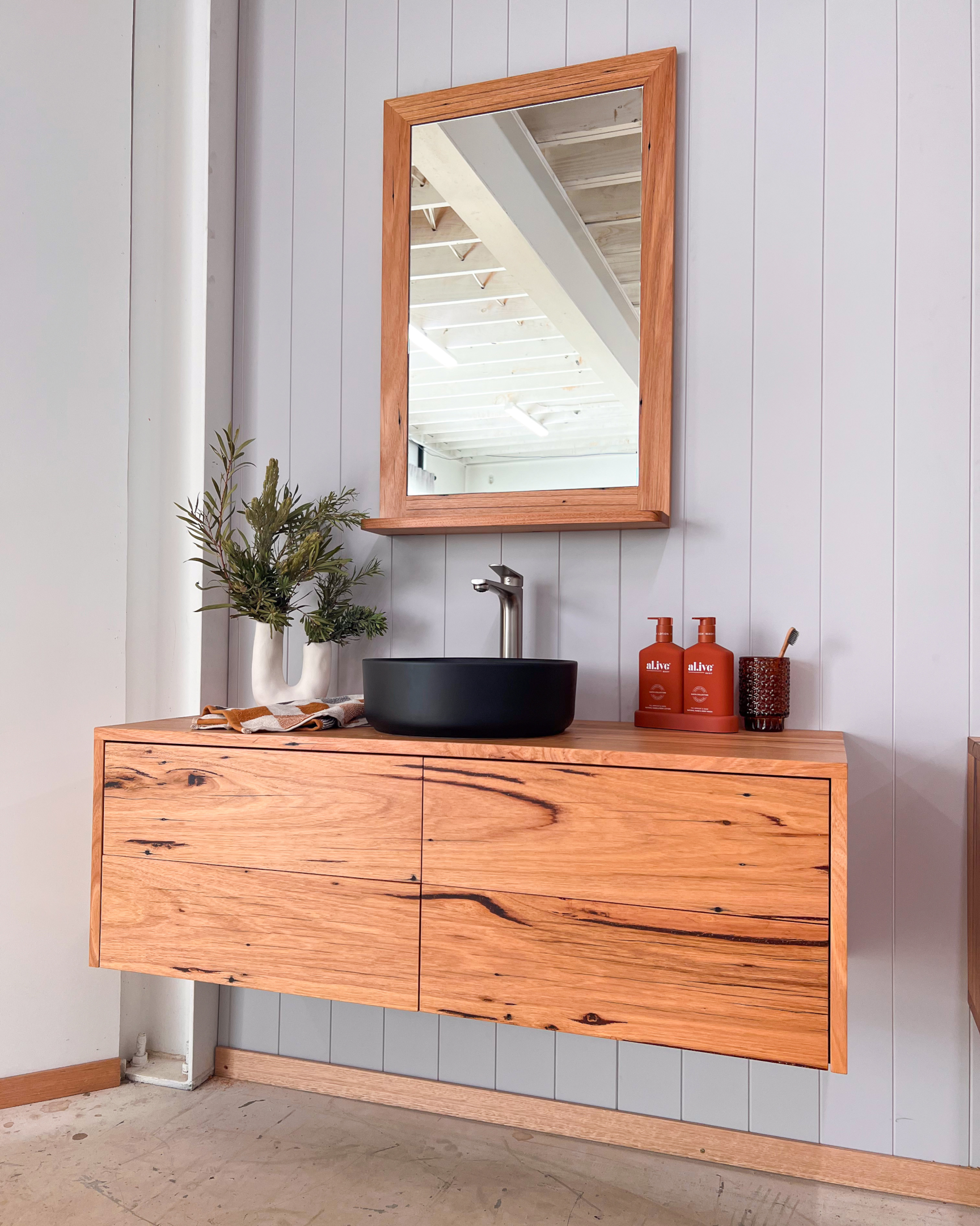 A small bathroom with a floating vanity, creating the illusion of more space