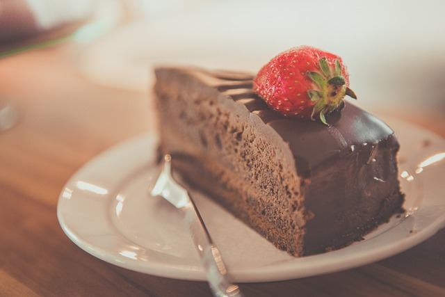 Decadent chocolate ganache cake with fresh strawberries for your next dinner party.