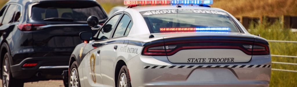 A police officer detains a motorist for potential violation of Michigan laws on Operating While Intoxicated (OWI) and Operating While Visibly Impaired (OWVI).