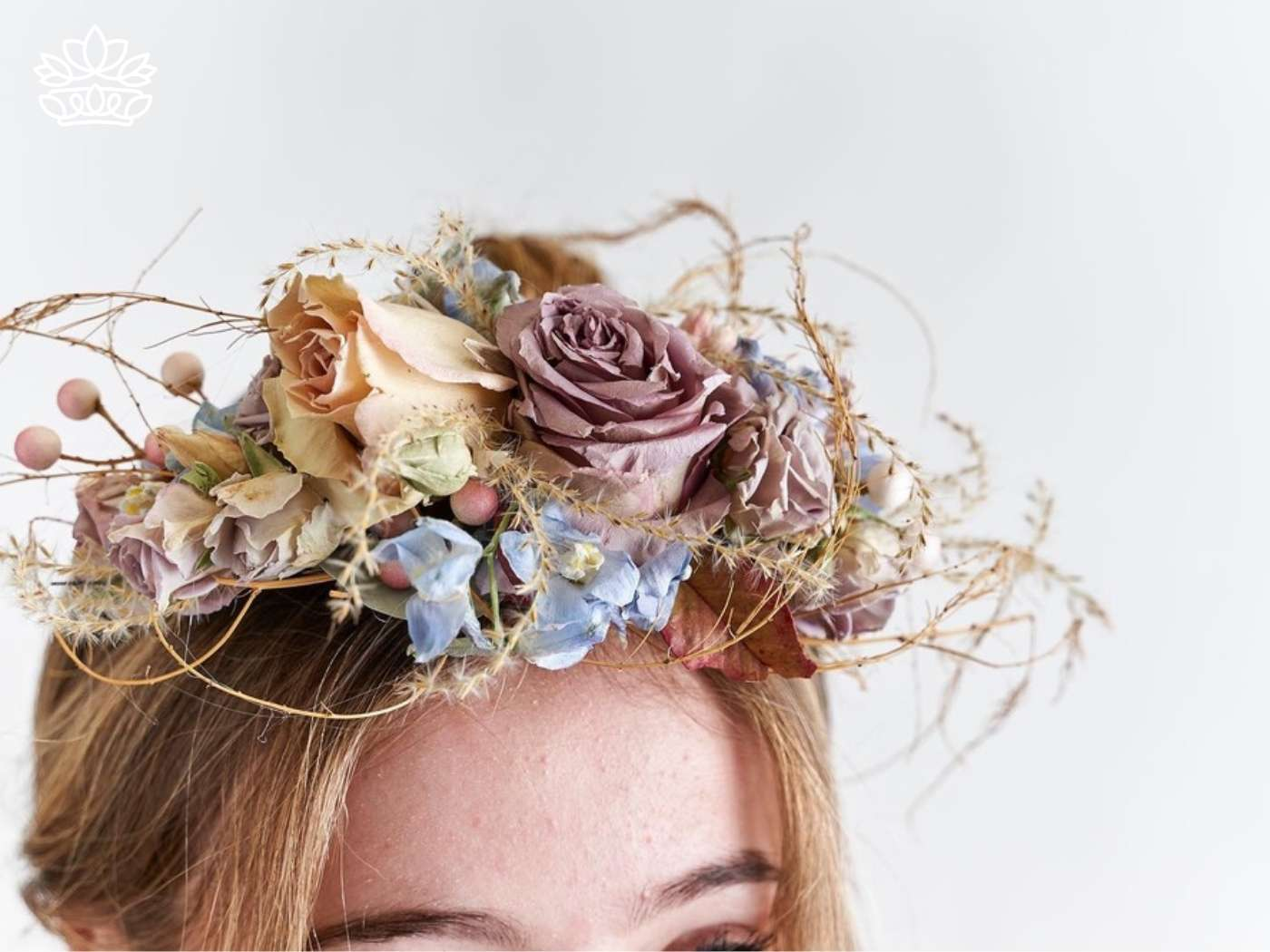 Close-up of a whimsical flower crown featuring a blend of dried roses and delicate botanicals, evoking a bohemian charm, part of the unique creations available at Fabulous Flowers and Gifts.