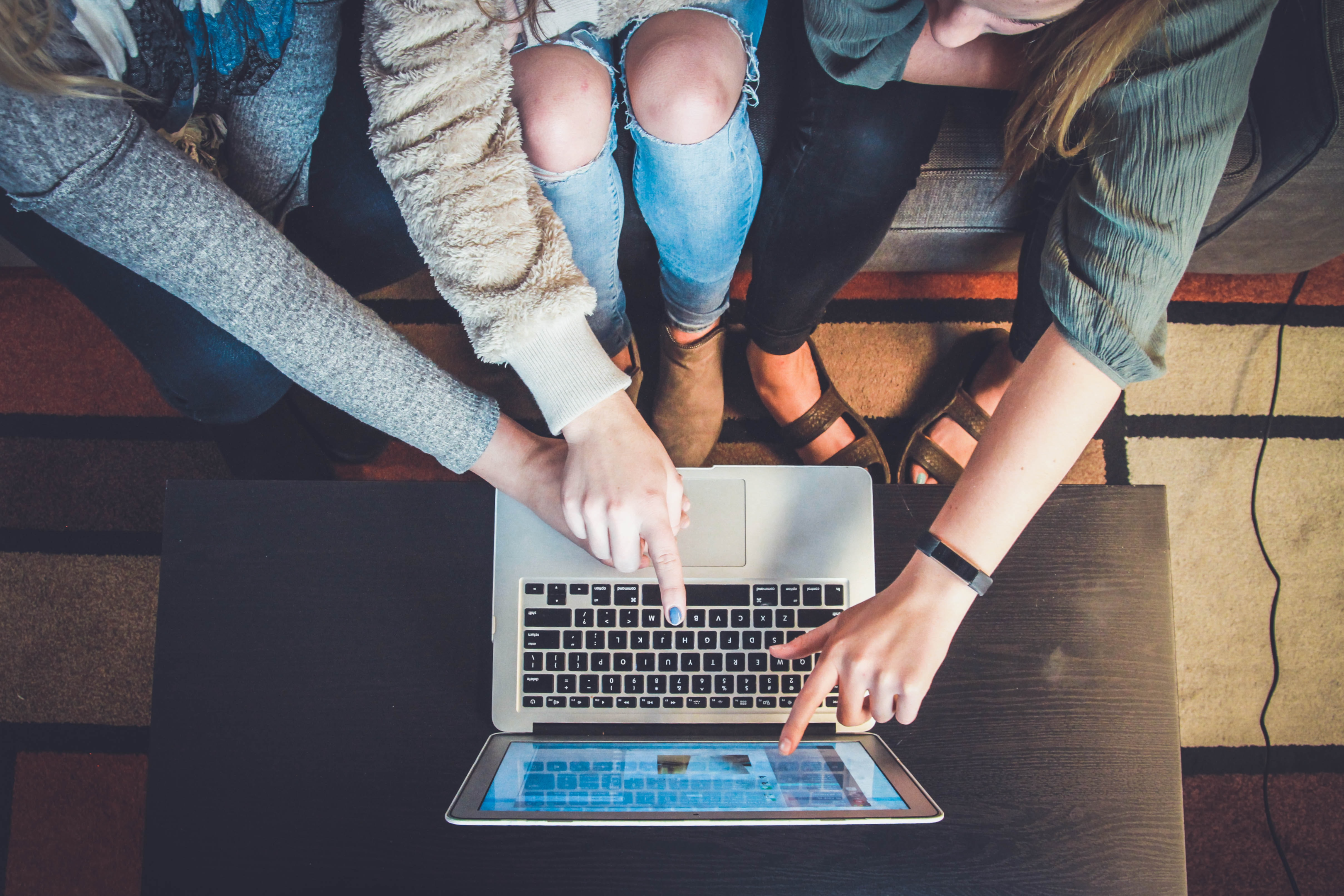 Group pointing at computer screen