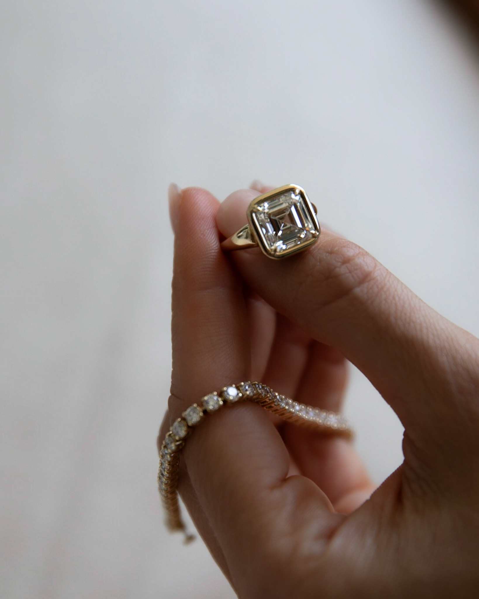 GOODSTONE club ring with an asscher cut diamond and a 5 carat tennis bracelet