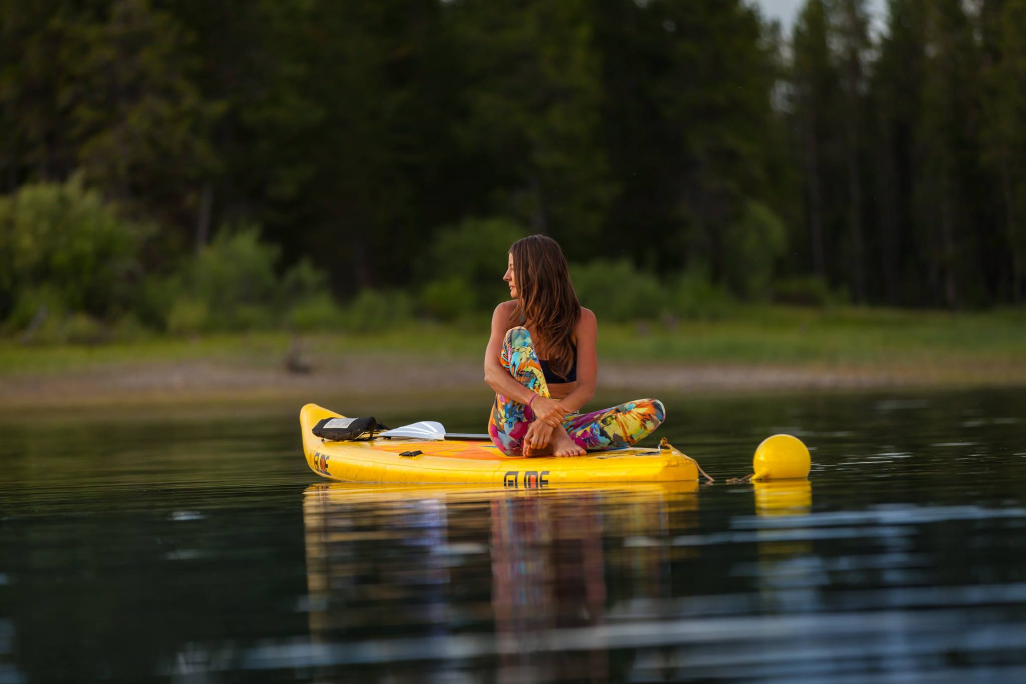 yoga on an inflatable paddle board