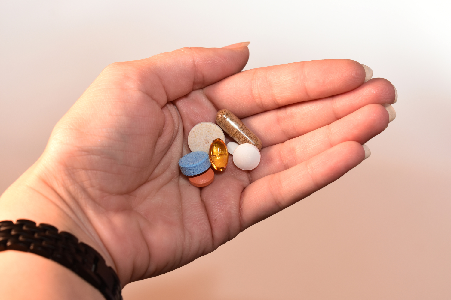 Customer holding several supplements.